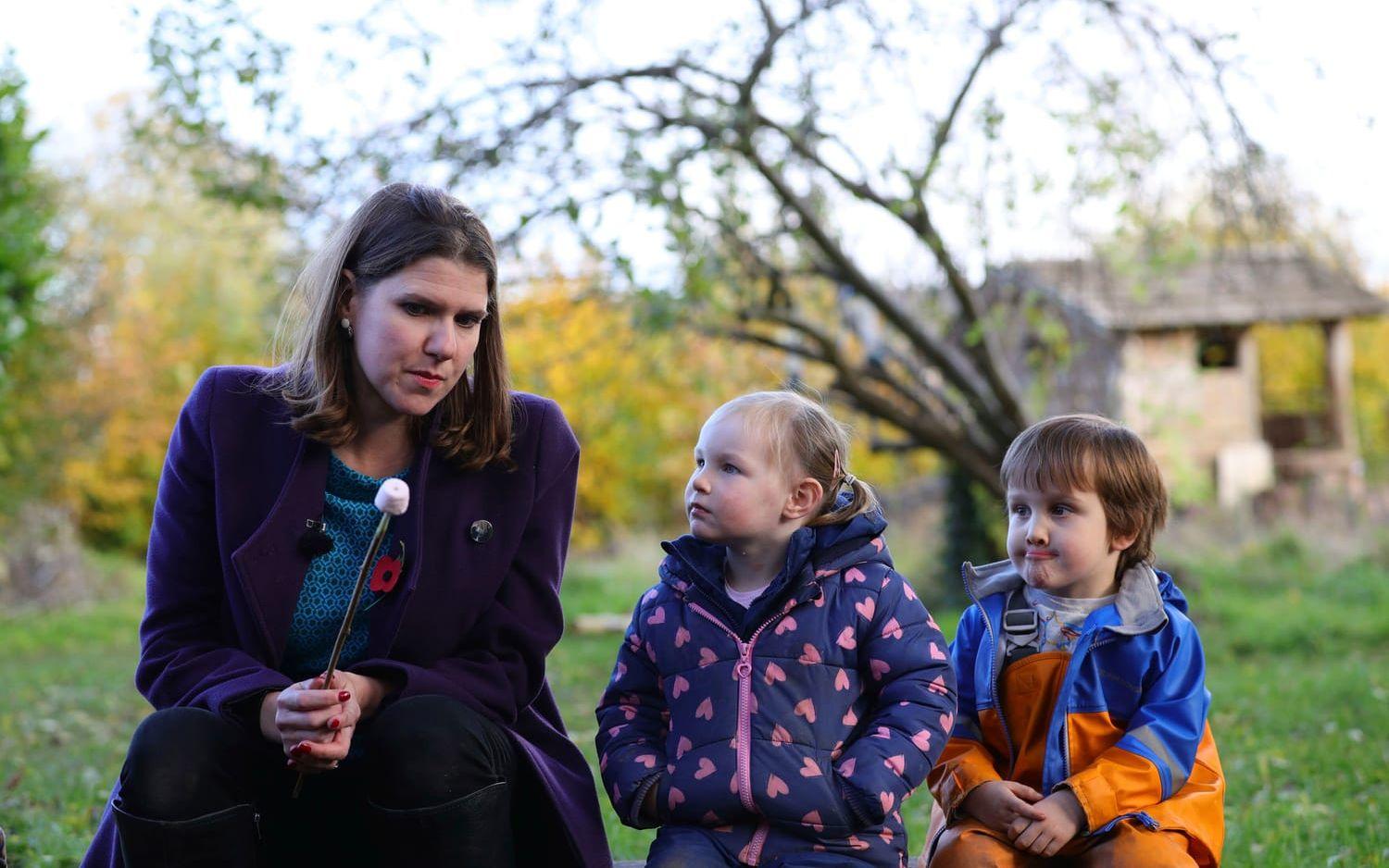 Britain's Liberal Democrats leader Jo Swinson prepares to eat a marshmallow as she sits with children at Free Rangers Nursery in Midsomer Norton for an engagement as part of the General Election campaign trail, in Somerset, England, Thursday, Nov. 7, 2019. Britain goes to the polls on Dec. 12.  (Aaron Chown/PA via AP)  TH805