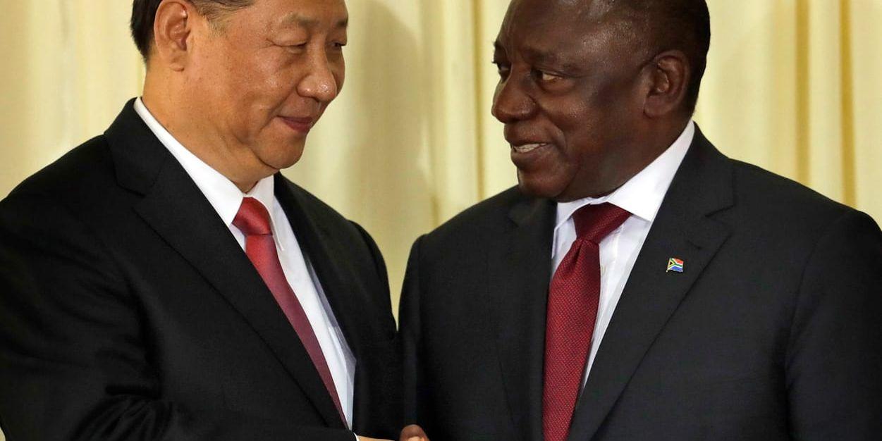 South African President Cyril Ramaphosa, right, shakes hand with Chinese President Xi Jinping after a joint press conference at the government's Union Buildings in Pretoria, South Africa, Tuesday, July 24, 2018. Jinping is in the country to attend the three-day BRICS Summit starting Wednesday in Johannesburg. (AP Photo/Themba Hadebe)