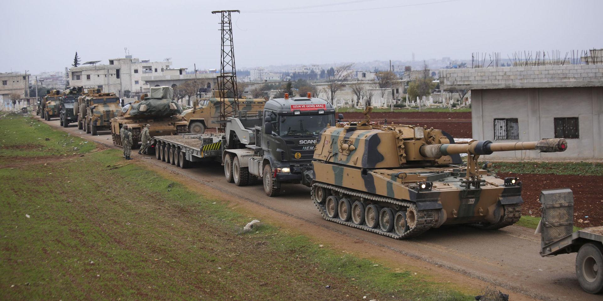 Turkish military convoy is seen near the town of Idlib, Syria, Wednesday, Feb. 12, 2020. Turkish President Recep Tayyip Erdogan said Wednesday that Turkey will attack government forces anywhere in Syria if another Turkish soldier is injured. (AP Photo/Ghaith Alsayed)  DV102