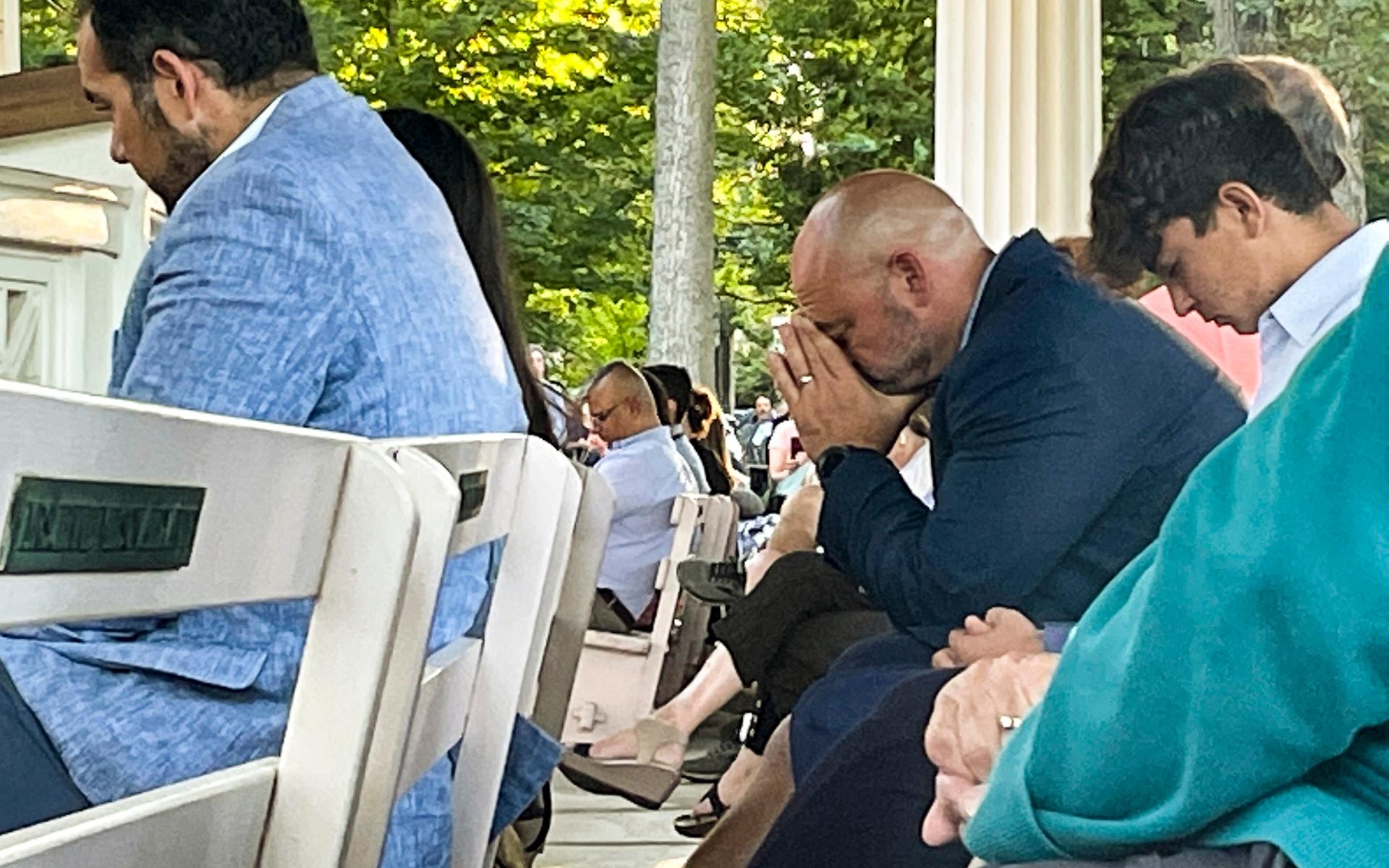 People gather at an evening vigil pray and observe a moment of silence after an attack on author Salman Rushdie, Friday Aug. 12, 2022, in Chautauqua, N.Y. Rushdie, whose novel &quot;The Satanic Verses&quot; drew death threats from Iran in the 1980s, was stabbed as he was about to give a lecture in western New York earlier today. (AP Photo/Joshua Goodman)  BMNY502