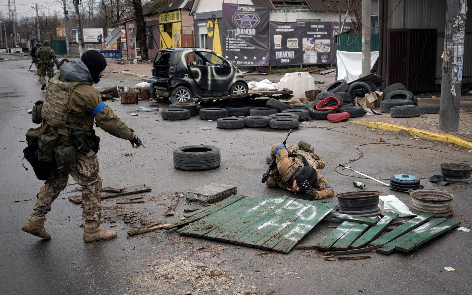 Ukrainian servicemen check streets for booby traps in the formerly Russian-occupied Kyiv suburb of Bucha, Ukraine, Saturday, April 2, 2022. As Russian forces pull back from Ukraine's capital region, retreating troops are creating a "catastrophic" situation for civilians by leaving mines around homes, abandoned equipment and "even the bodies of those killed," President Volodymyr Zelenskyy warned Saturday.(AP Photo/Vadim Ghirda)  XVG154